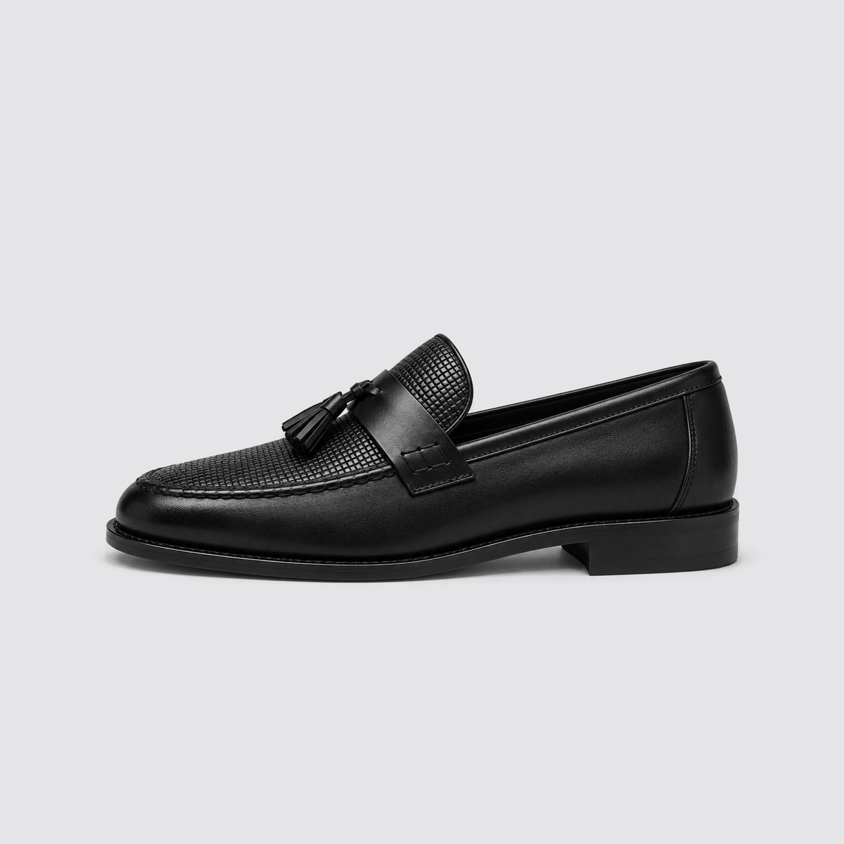 Black woven tassel loafer side profile